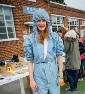 Amie Taylor dressed in a blue forensic suit at Brockwell Lido Fun Palace in 2016