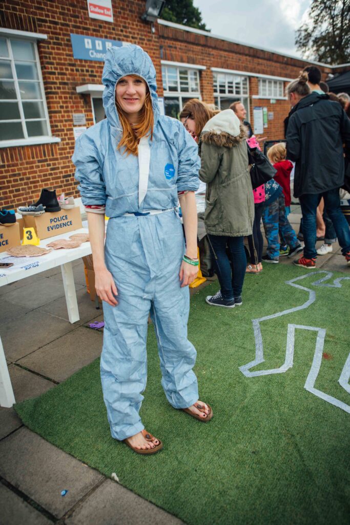 Amie Taylor dressed in a blue forensic suit at Brockwell Lido Fun Palace in 2016