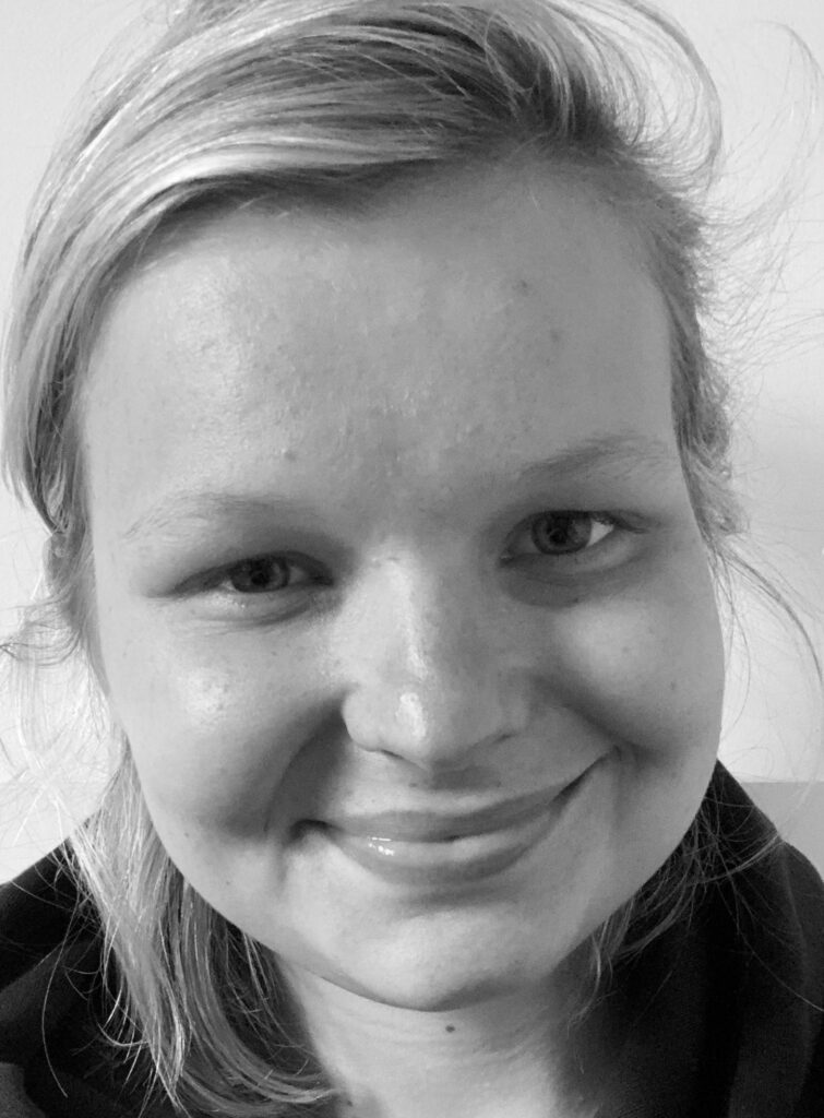 Black and white photo of Beth Sedgwick, a smiling woman with blonde hair.