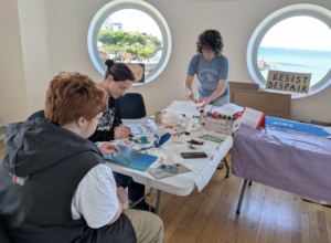 Picture of Gemma and some visitors making protest banners at The Arcadia in Portrush