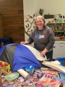 Picture of Tamasin making an umbrella with arts materials in the foreground