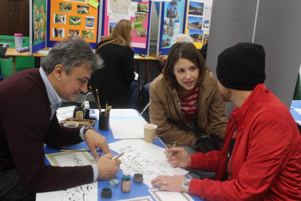 Picture of people practising Arabic calligraphy