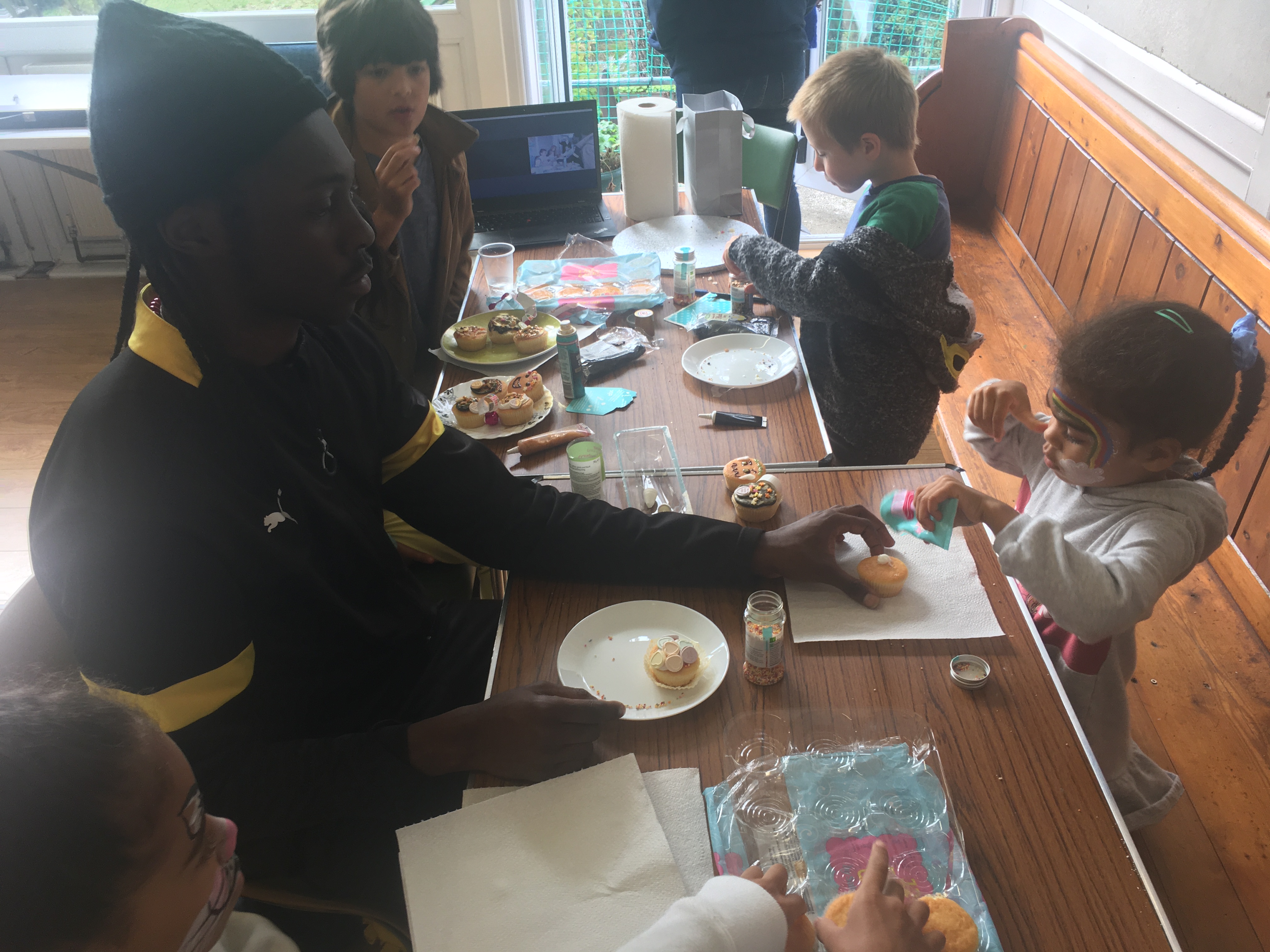 Brandon using his Chef skills showing one of our future how to decorate cup cakes